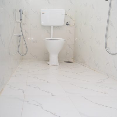 Marble-tiled bathroom with shower and health faucet at Zest Stays 1054