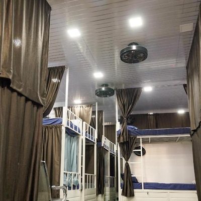 Row of bunk beds with individual privacy curtains at Zest Stays 1054