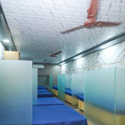 Frosted-glass partitioned beds in the common partition area at Zest Stays 1054