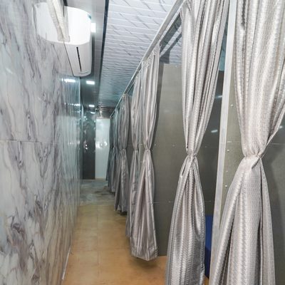 Corridor of curtained private partitions with wall-mounted air conditioning